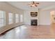 Bright living room with fireplace, hardwood floors, and large windows at 806 Relic Rdg, Hampton, GA 30228