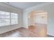 Bright living room features an archway, hardwood floors, and large windows, creating an inviting space at 806 Relic Rdg, Hampton, GA 30228