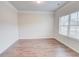 Well-lit living room with hardwood floors, crown molding, and a large window offering natural light at 806 Relic Rdg, Hampton, GA 30228