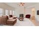 Sun-filled living room with modern furniture, fireplace, and large windows at 806 Relic Rdg, Hampton, GA 30228