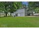 Spacious backyard with a lush green lawn, white stairs, and mature trees at 1094 Regent Sw St, Atlanta, GA 30310