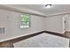 Well-lit basement area with dark hardwood floors and a large window at 1094 Regent Sw St, Atlanta, GA 30310