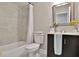 Tiled bathroom with a shower-tub combination and dark vanity at 1094 Regent Sw St, Atlanta, GA 30310