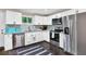 Well-lit kitchen with stainless steel appliances, white cabinets, granite countertops and a window view at 1094 Regent Sw St, Atlanta, GA 30310