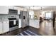 Open concept kitchen with stainless steel appliances, granite counters, and an adjacent living area at 1094 Regent Sw St, Atlanta, GA 30310