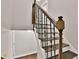 Elegant staircase with wood railing and wrought iron spindles ascending from hardwood floor at 1094 Regent Sw St, Atlanta, GA 30310