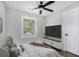 Comfortable bedroom featuring neutral colors, a large window, and a modern ceiling fan at 1934 Pinedale Pl, Decatur, GA 30032