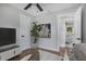 Serene bedroom with a TV, a large window offering natural light, and hardwood floors at 1934 Pinedale Pl, Decatur, GA 30032