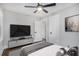Comfortable bedroom with natural lighting, ceiling fan, and a stylish console and tv at 1934 Pinedale Pl, Decatur, GA 30032