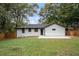 Charming home featuring a well-maintained lawn, concrete patio, and fresh black and white exterior at 1934 Pinedale Pl, Decatur, GA 30032