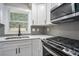 Close-up of kitchen details, including stainless steel appliances and modern backsplash at 1934 Pinedale Pl, Decatur, GA 30032