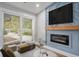 Cozy living room featuring a modern fireplace, large windows, and stylish furniture at 1934 Pinedale Pl, Decatur, GA 30032