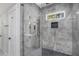 Updated glass shower boasts sleek gray tiling, a rain shower head, and a small window at 1934 Pinedale Pl, Decatur, GA 30032