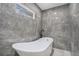 Elegant bathroom featuring a modern freestanding tub and marble-look tile at 1934 Pinedale Pl, Decatur, GA 30032