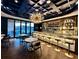 Elegant bar featuring a striking chandelier, luxurious seating, and an extensive liquor selection at 260 Guild Ln, Fayetteville, GA 30214