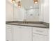 Bright bathroom featuring a vanity with stone countertop, a large mirror, and modern fixtures at 260 Guild Ln, Fayetteville, GA 30214