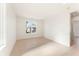 Sun-filled bedroom with blonde hardwood floors, white walls, and large window for natural light at 260 Guild Ln, Fayetteville, GA 30214