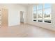 A bright room with a view into the bathroom area, showcasing the hardwood floors and white walls at 260 Guild Ln, Fayetteville, GA 30214