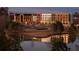 Stunning multi-story building complex reflected beautifully across a tranquil lake at dusk at 260 Guild Ln, Fayetteville, GA 30214