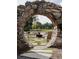 Inviting outdoor fire pit area, framed by a stone archway, perfect for relaxation and gatherings at 260 Guild Ln, Fayetteville, GA 30214