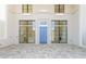 This covered outdoor space features a blue front door, tile floor, and windows on either side at 260 Guild Ln, Fayetteville, GA 30214