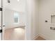 Hallway view into a bedroom with blonde hardwood floors and a window at 260 Guild Ln, Fayetteville, GA 30214