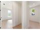 Hallway shows views of a bedroom and another room with blonde hardwood floors and natural light at 260 Guild Ln, Fayetteville, GA 30214