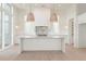 Bright kitchen with a center island and white cabinetry, with stainless steel appliances and pendant lights at 260 Guild Ln, Fayetteville, GA 30214