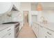 Bright kitchen with stainless steel appliances, marble countertops, and a large range hood at 260 Guild Ln, Fayetteville, GA 30214