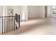 Landing with iron railing staircase, hardwood floors, and natural light from a window at 260 Guild Ln, Fayetteville, GA 30214