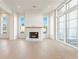 A bright living room featuring hardwood floors, a modern fireplace, and large windows for natural light at 260 Guild Ln, Fayetteville, GA 30214