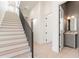 Light wood staircase features iron railing and leads to a landing with gray vanity bathroom at 260 Guild Ln, Fayetteville, GA 30214