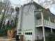 Rear exterior featuring a two-car garage and staircase at 4481 Dunmovin Nw Dr, Kennesaw, GA 30144