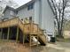 Backyard view featuring a spacious wooden deck with stairs and grey siding at 4481 Dunmovin Nw Dr, Kennesaw, GA 30144
