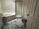 Bathroom with a tub, shower, and hexagonal tile flooring at 4481 Dunmovin Nw Dr, Kennesaw, GA 30144