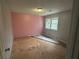 Bedroom with a pink wall and a window, providing natural light at 4481 Dunmovin Nw Dr, Kennesaw, GA 30144