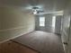 Spacious bedroom featuring neutral walls, carpeted floors, a ceiling fan, and natural light from windows at 4481 Dunmovin Nw Dr, Kennesaw, GA 30144