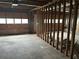 Unfinished garage space with exposed framing and a roll-up door, awaiting customization and completion at 4481 Dunmovin Nw Dr, Kennesaw, GA 30144
