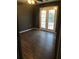 Bedroom featuring a hardwood floor, and double doors that lead to the outside at 6434 Wellington Chase Ct # 6434, Lithonia, GA 30058
