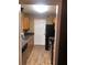 View of the kitchen featuring wood cabinets, a sink, and laminate flooring at 6434 Wellington Chase Ct # 6434, Lithonia, GA 30058