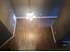 Top down view of the open living room featuring a chandelier, hardwood floor, and high ceilings at 6434 Wellington Chase Ct # 6434, Lithonia, GA 30058
