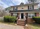 Charming two-story home featuring a brick facade, black shutters and a well-manicured front yard at 1606 King Rd, Riverdale, GA 30296