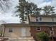 The home's rear exterior features a neutral siding with an access door at 1606 King Rd, Riverdale, GA 30296