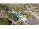 An aerial view of tennis courts, a pool and play area in a neighborhood setting at 53 Weatherstone Pkwy, Marietta, GA 30068
