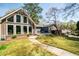 Charming backyard view of home with large windows, a paved patio, and established landscaping at 53 Weatherstone Pkwy, Marietta, GA 30068