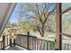 Charming balcony with wooded view, natural light and wooden railings overlooking the surrounding neighborhood at 53 Weatherstone Pkwy, Marietta, GA 30068