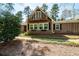 Two-story home with charming balcony, surrounded by beautiful trees and stone pathway at 53 Weatherstone Pkwy, Marietta, GA 30068