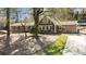 Charming two-story home featuring wood siding, black shutters, mature trees, and a small balcony at 53 Weatherstone Pkwy, Marietta, GA 30068