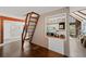 Bright room featuring hardwood floors, a brick wall, and a unique ladder to the attic space above at 53 Weatherstone Pkwy, Marietta, GA 30068