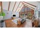 Bright living room boasting vaulted ceilings, wood beams, large windows, hardwood floors and modern decor at 53 Weatherstone Pkwy, Marietta, GA 30068